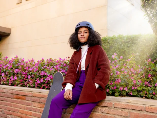 A woman confidently standing outdoors.