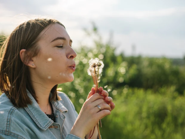 A woman confidently standing outdoors.