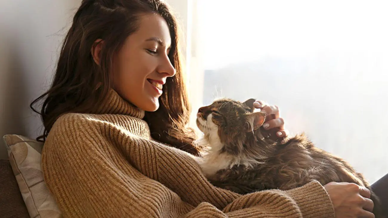 lady lying in bed with her cat